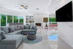 Living Room Features 75 Inch TV, Bar Area with Wine Refrigerator And Pool Views